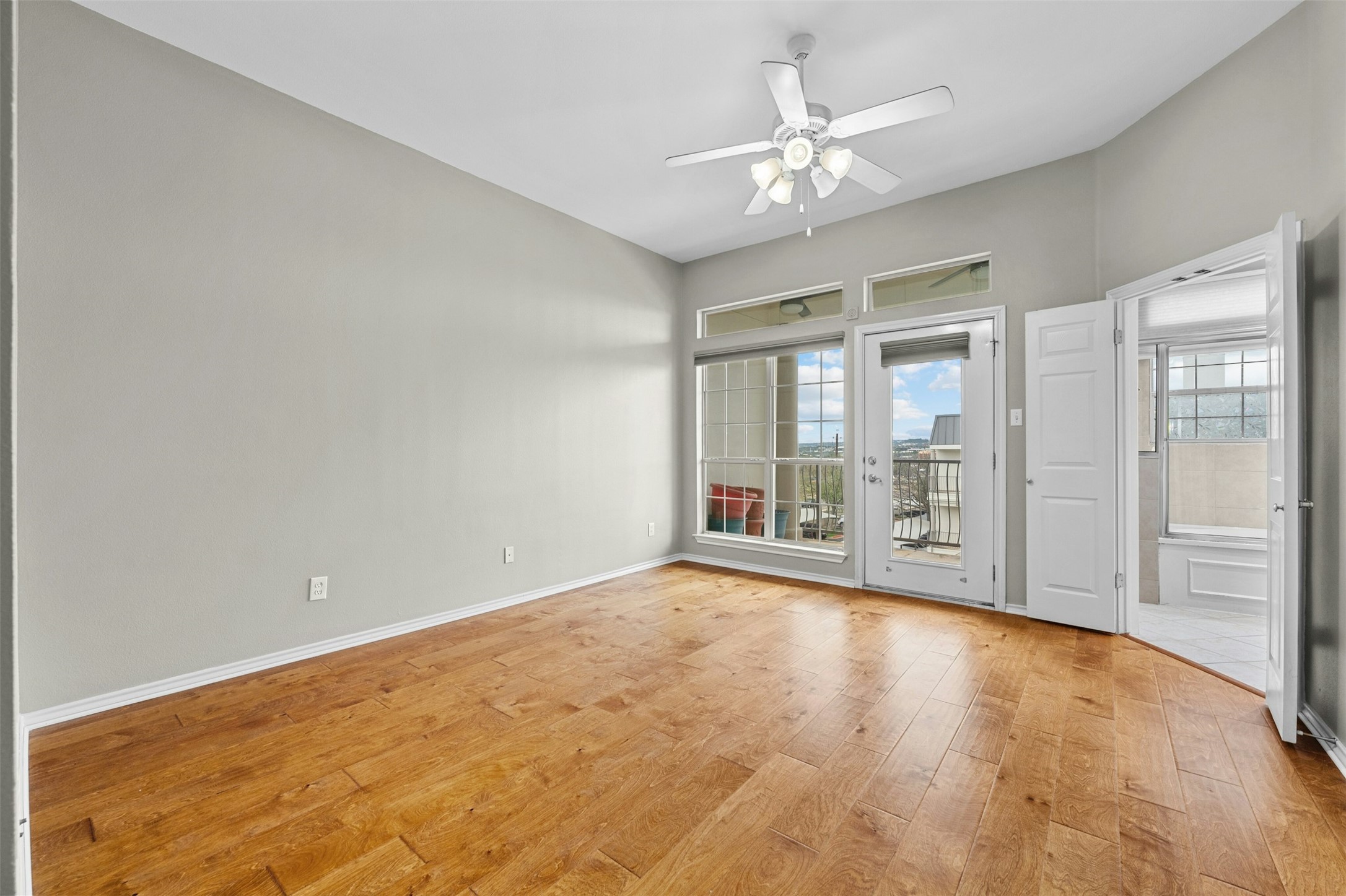 2918 Ranch Road 620 North, Unit W219 Austin, TX 78734 - Photo 19 of 35 a view of an empty room with chandelier fan and a large window