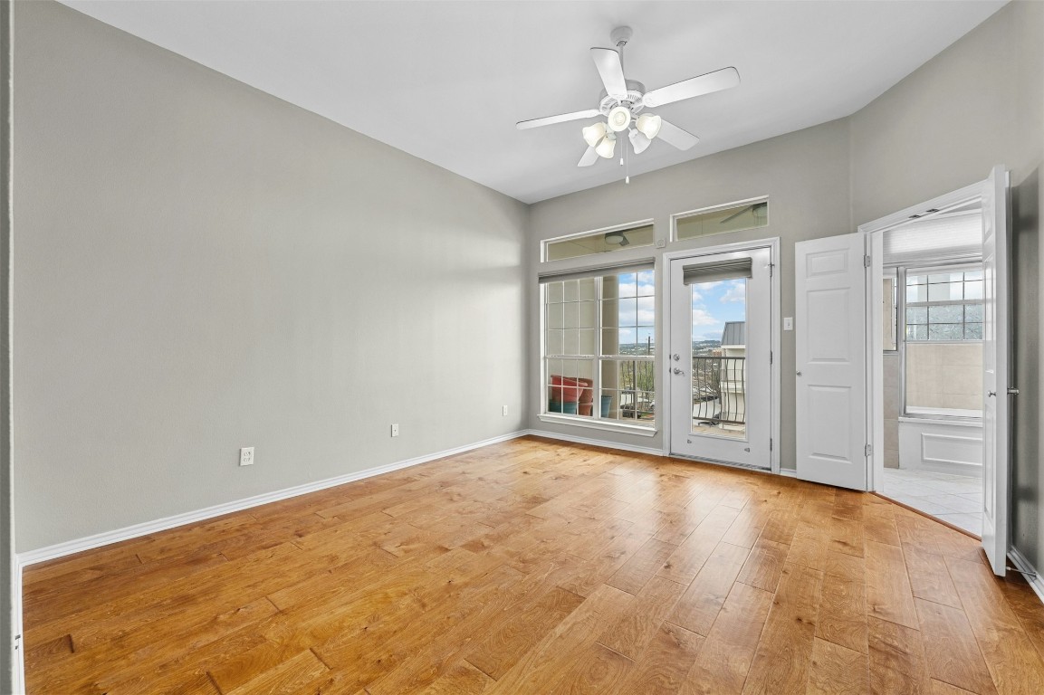 2918 Ranch Road 620 North, Unit W219 Austin, TX 78734 - Photo 19 of 35 a view of an empty room with chandelier fan and a large window