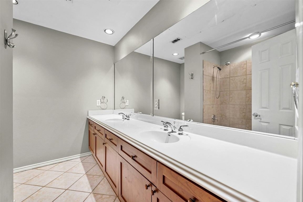 2918 Ranch Road 620 North, Unit W219 Austin, TX 78734 - Photo 29 of 35 a bathroom with a sink double vanity and a mirror