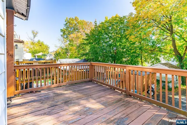 a view of a house with a small deck and a wooden deck