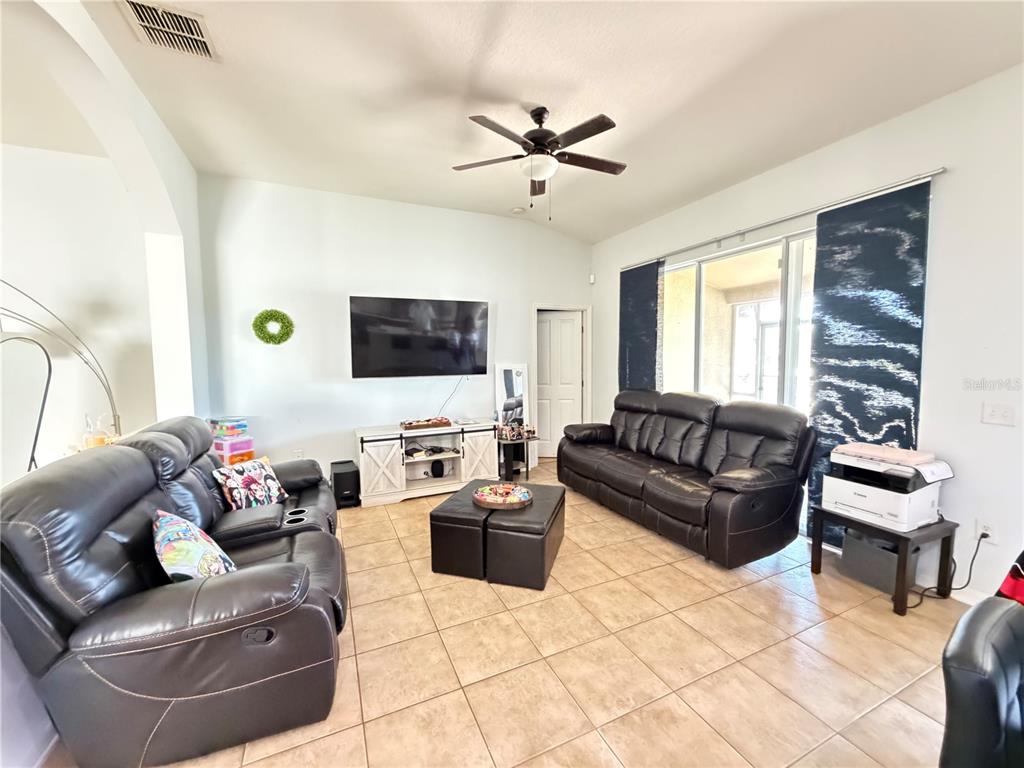 945 Tramells Trail Kissimmee, FL 34744 - Photo 10 of 36 a living room with furniture and a flat screen tv