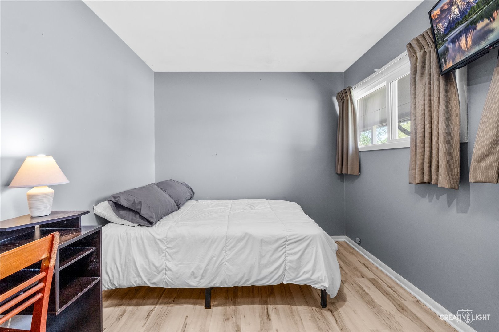4 Woodcliff Road Montgomery, IL 60538 - Photo 11 of 18 a bedroom with a bed and a lamp with window