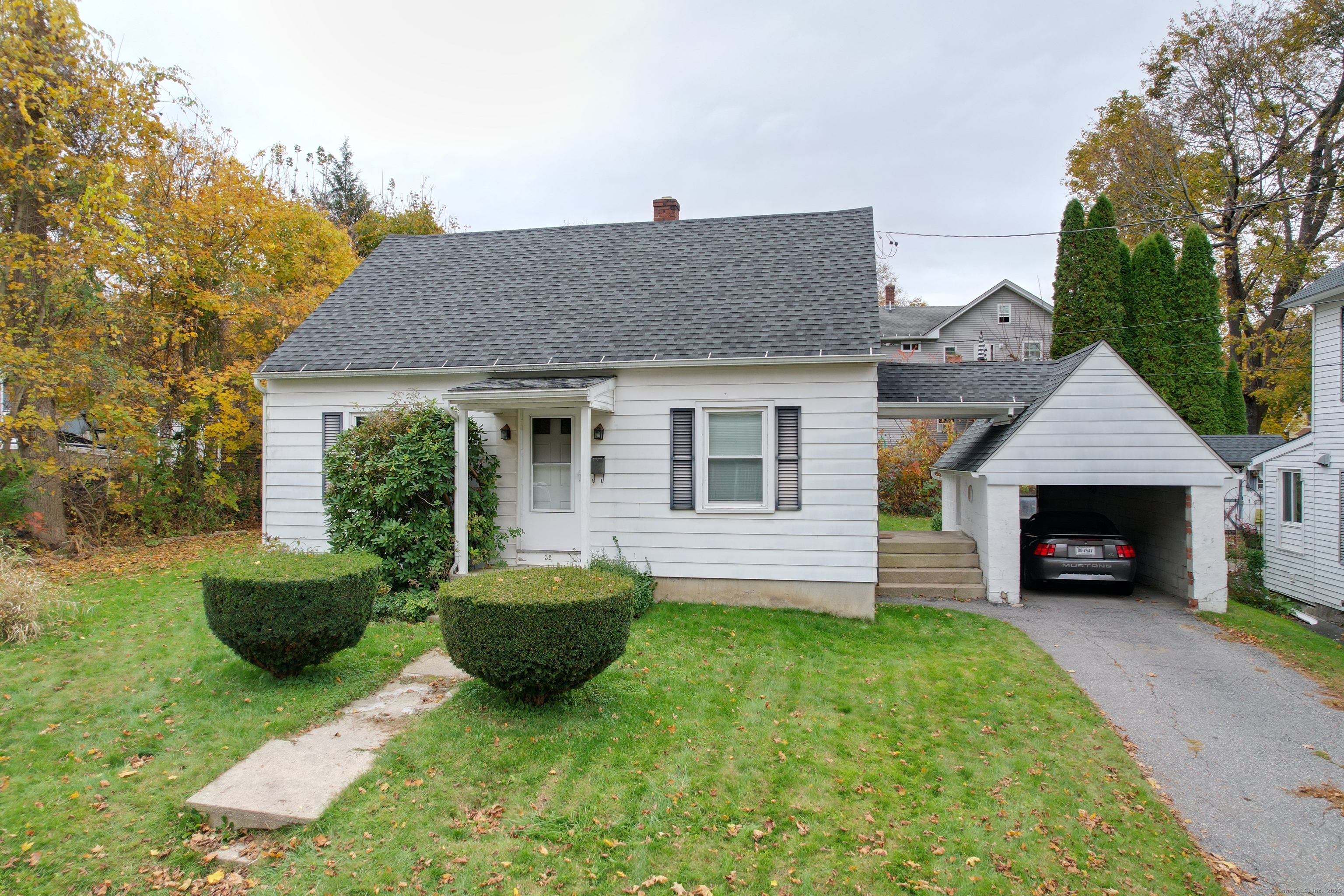a view of a house with a yard and a garden