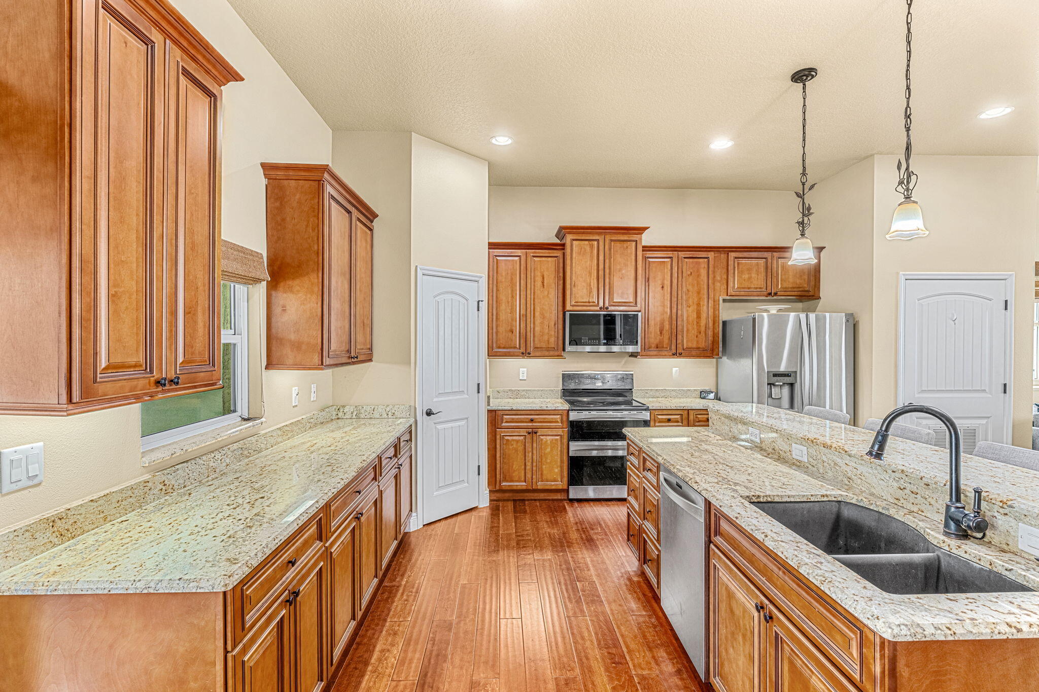 3119 Indian River Drive Cocoa, FL 32922 - Photo 13 of 47 a kitchen with stainless steel appliances granite countertop a sink stove and refrigerator