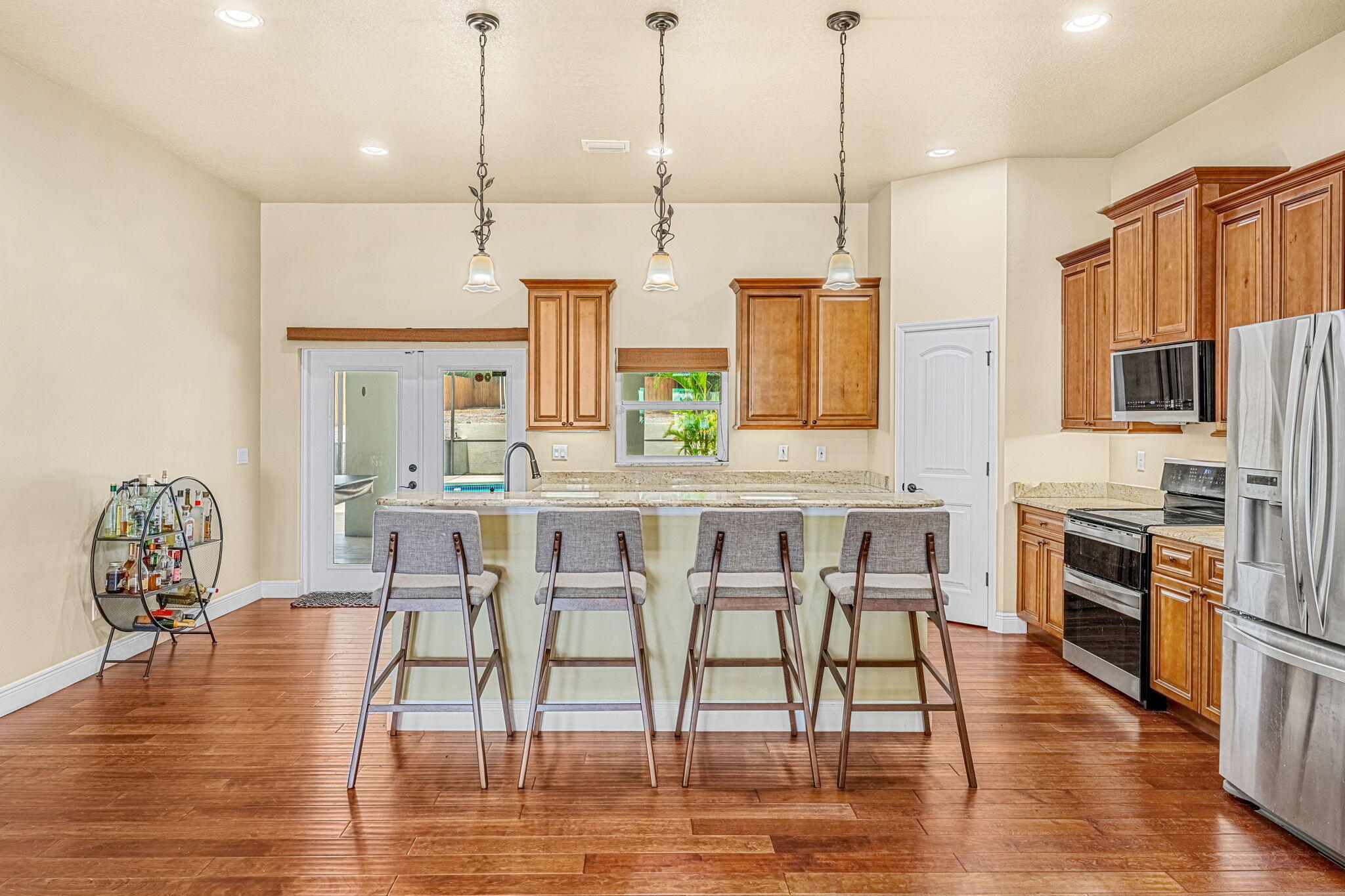 3119 Indian River Drive Cocoa, FL 32922 - Photo 15 of 47 a dining table chairs wooden floor and a kitchen view