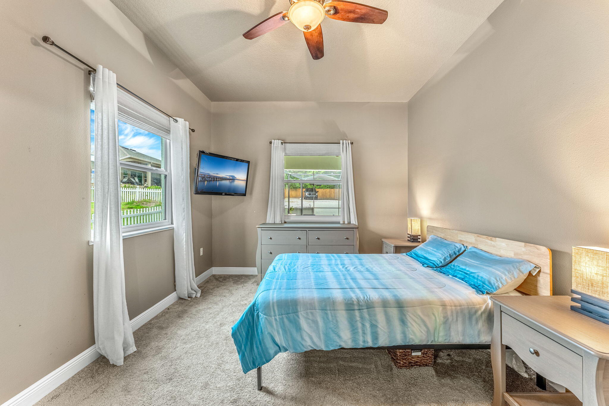 3119 Indian River Drive Cocoa, FL 32922 - Photo 16 of 47 a bedroom with a bed and a chandelier