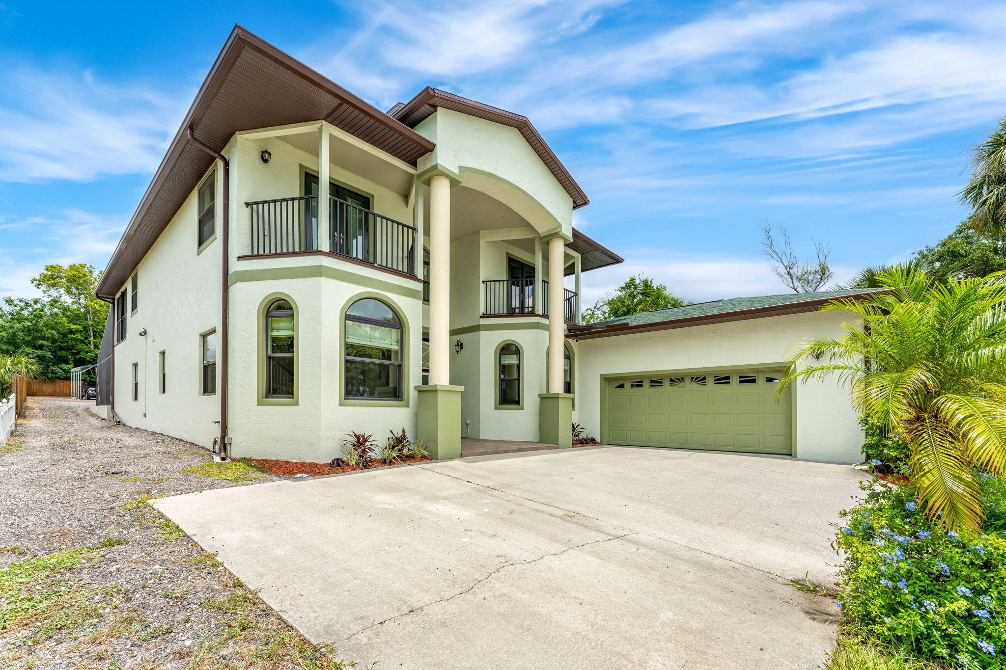 3119 Indian River Drive Cocoa, FL 32922 - Photo 2 of 47 a front view of a house with a garden