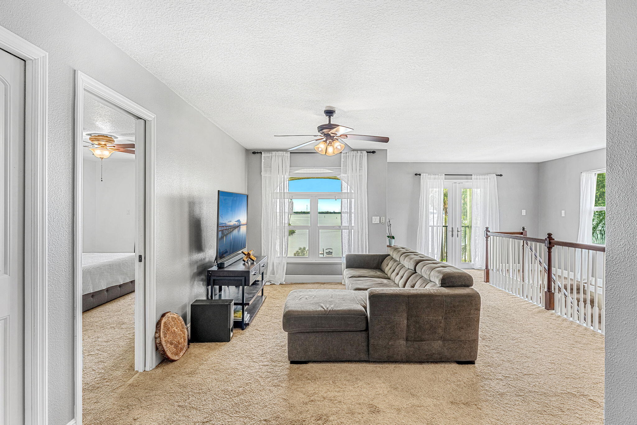 3119 Indian River Drive Cocoa, FL 32922 - Photo 22 of 47 a living room with furniture a chandelier and a window