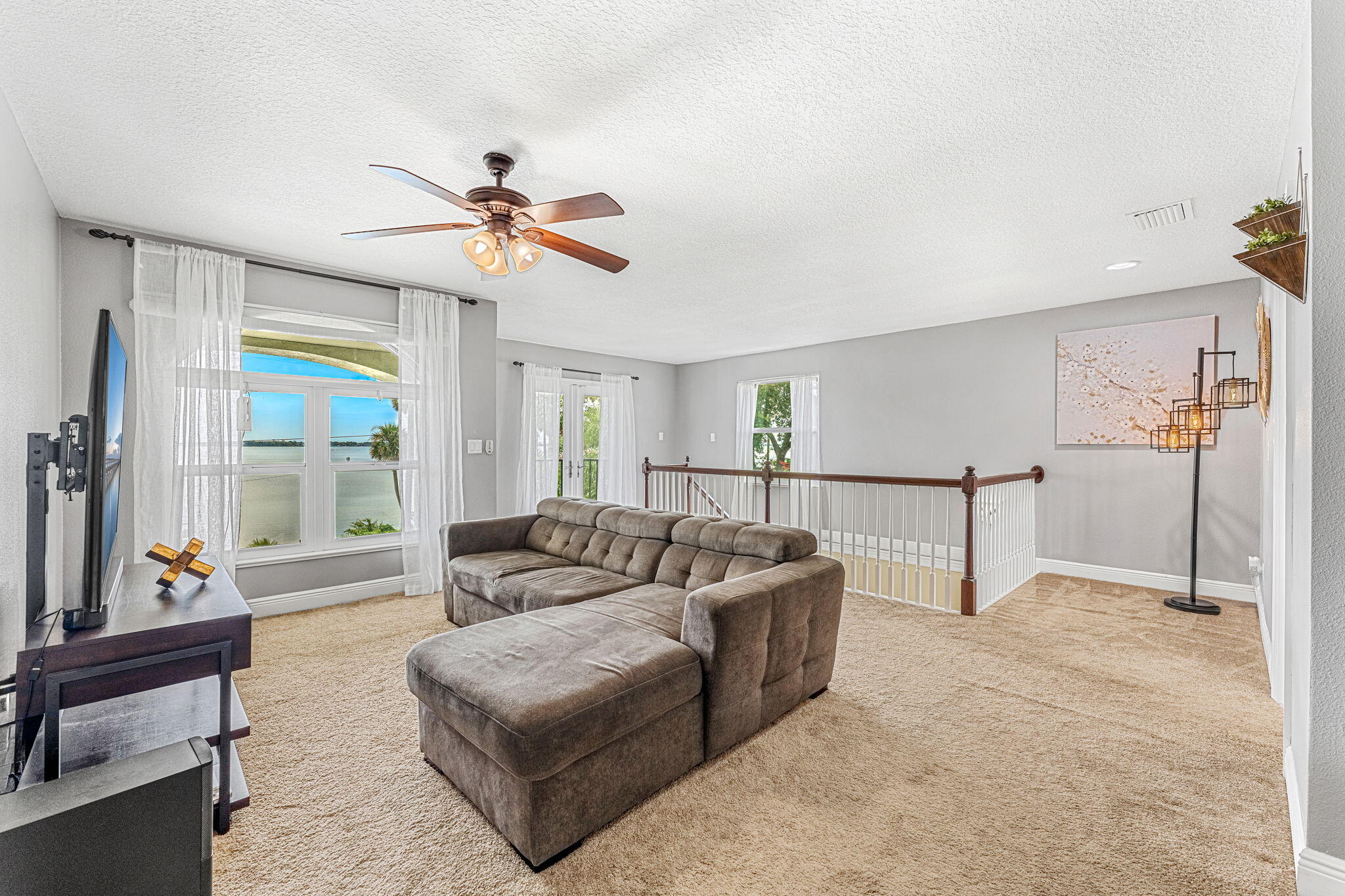 3119 Indian River Drive Cocoa, FL 32922 - Photo 23 of 47 a living room with furniture and a chandelier