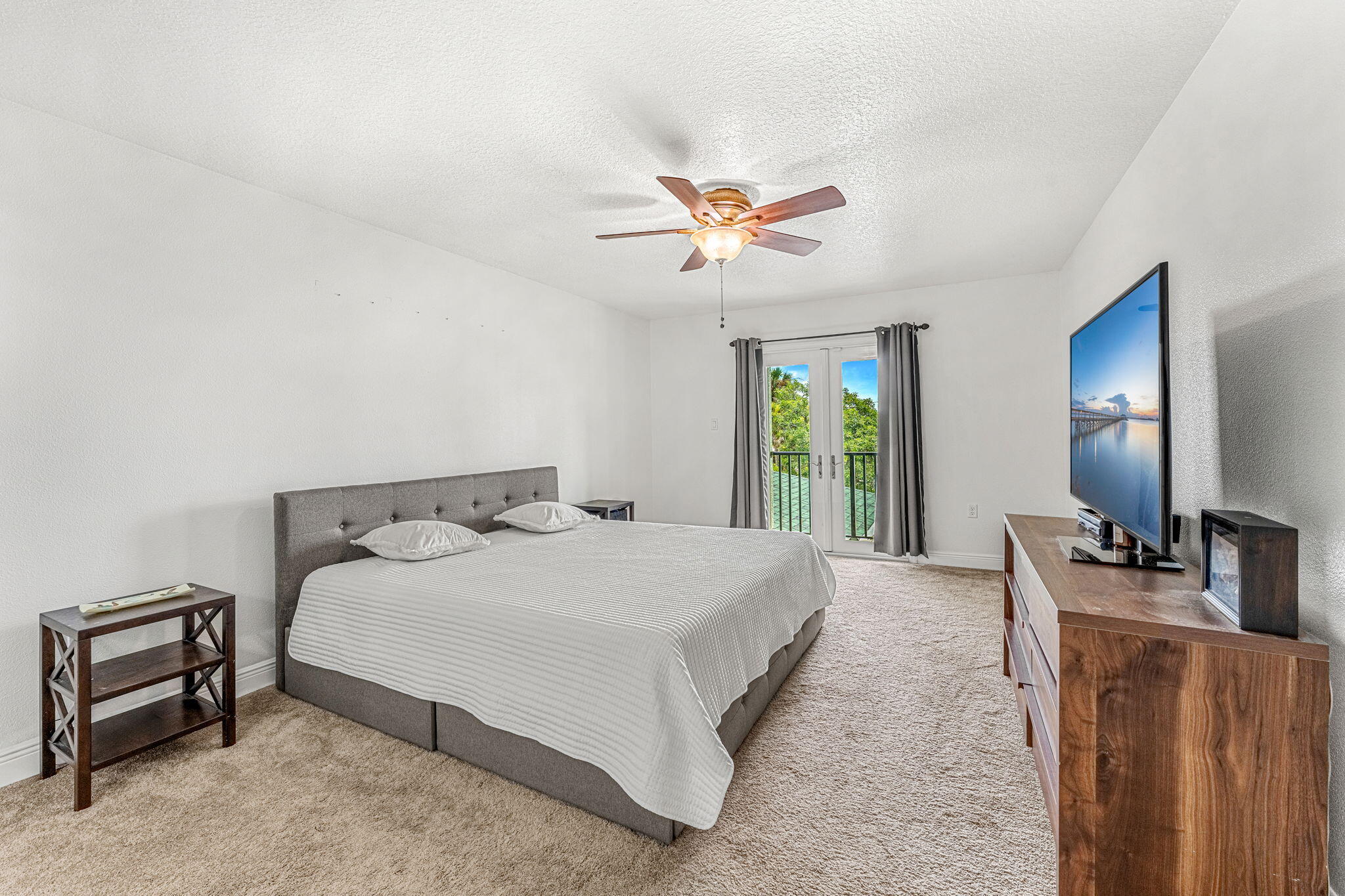 3119 Indian River Drive Cocoa, FL 32922 - Photo 24 of 47 a bedroom with a bed and a chandelier