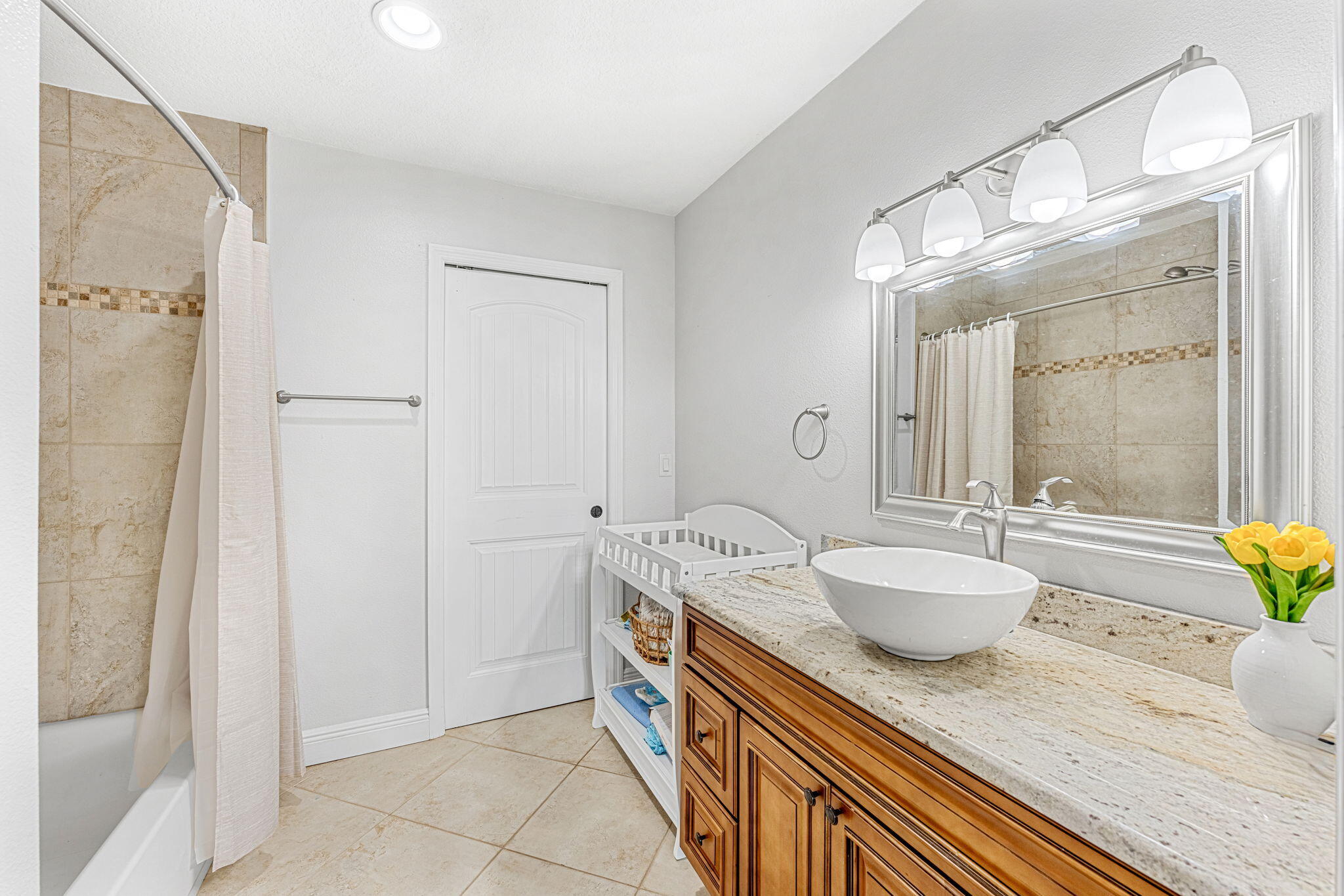 3119 Indian River Drive Cocoa, FL 32922 - Photo 28 of 47 a spacious bathroom with a granite countertop sink and a mirror
