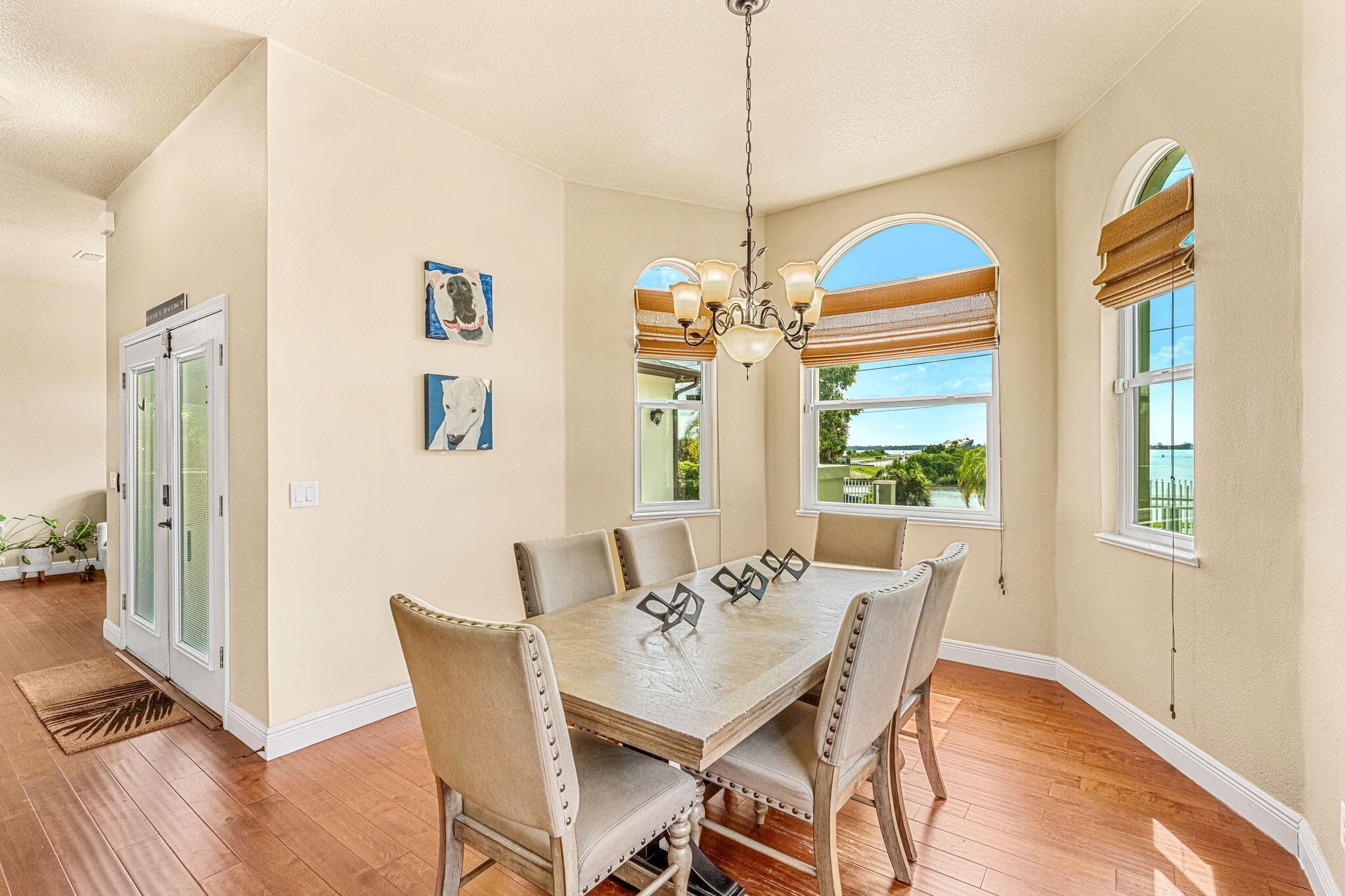 3119 Indian River Drive Cocoa, FL 32922 - Photo 5 of 47 a dining room with furniture a chandelier and wooden floor