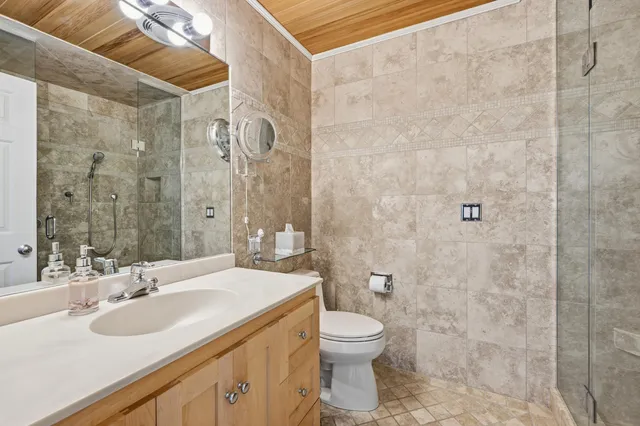 a bathroom with a sink toilet and shower