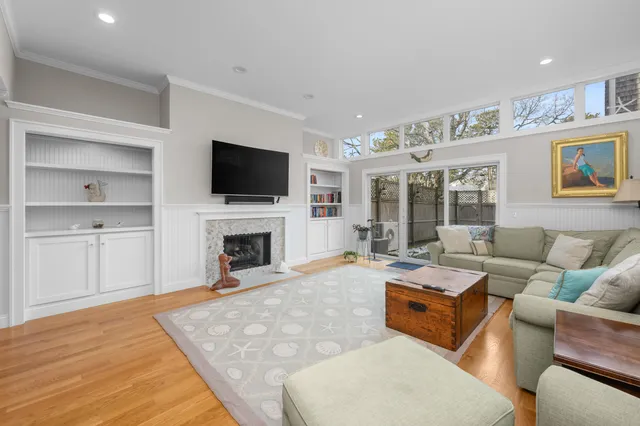 a living room with furniture a fireplace and a flat screen tv