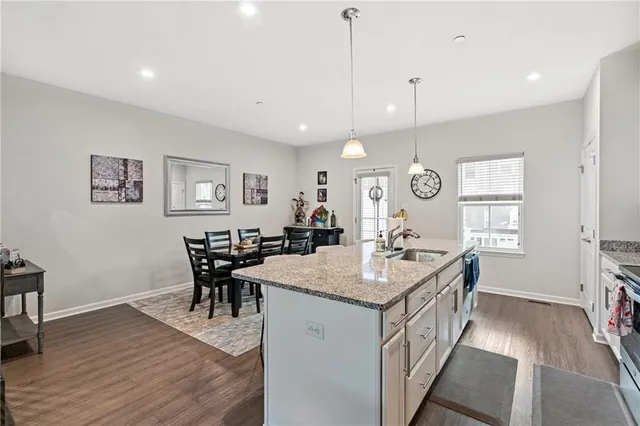 a very nice looking dining room with kitchen island a table and chairs