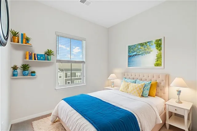 a bedroom with a bed and a window