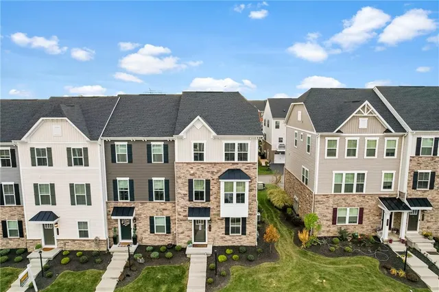 an aerial view of residential houses with outdoor space