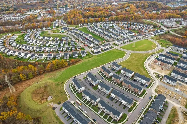 a front view of a house with a garden and yard