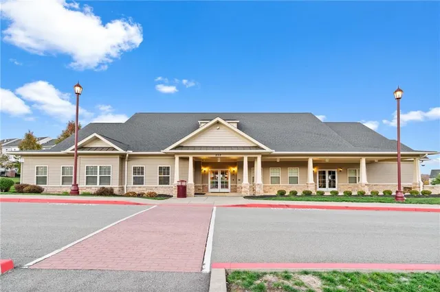 a living room with lots of furniture and kitchen view