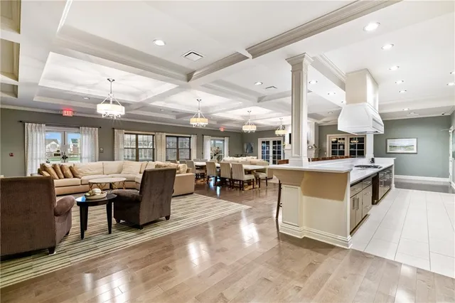 a large kitchen with stainless steel appliances kitchen island a large counter top and a refrigerator