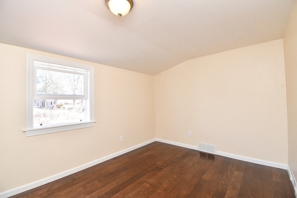 88 Dimmick Street Springfield, MA 01109 - Photo 15 of 36 an empty room with wooden floor and windows