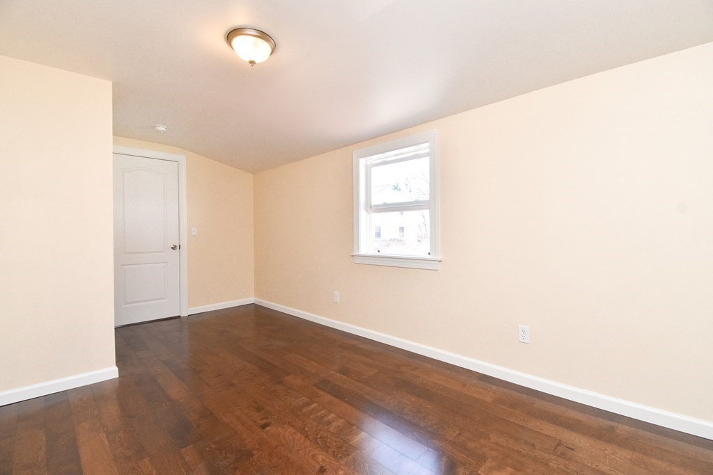 88 Dimmick Street Springfield, MA 01109 - Photo 16 of 36 an empty room with wooden floor and windows