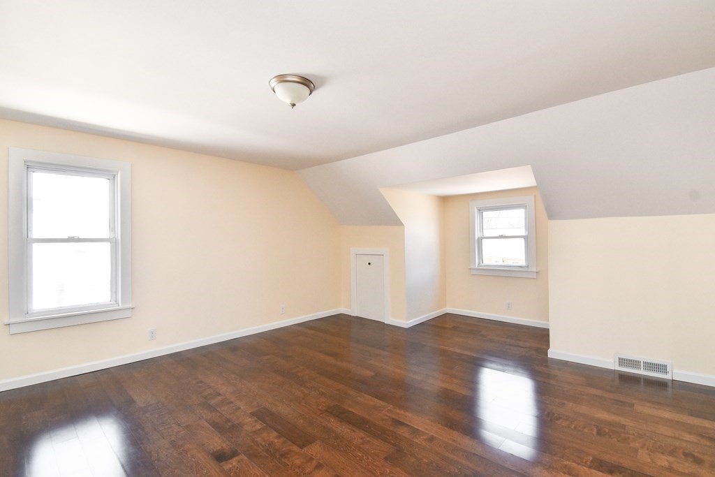 88 Dimmick Street Springfield, MA 01109 - Photo 20 of 36 an empty room with wooden floor and windows