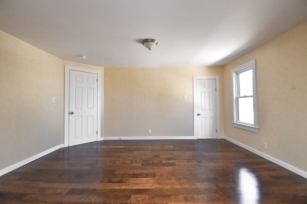 88 Dimmick Street Springfield, MA 01109 - Photo 23 of 36 a view of an empty room with wooden floor and a window