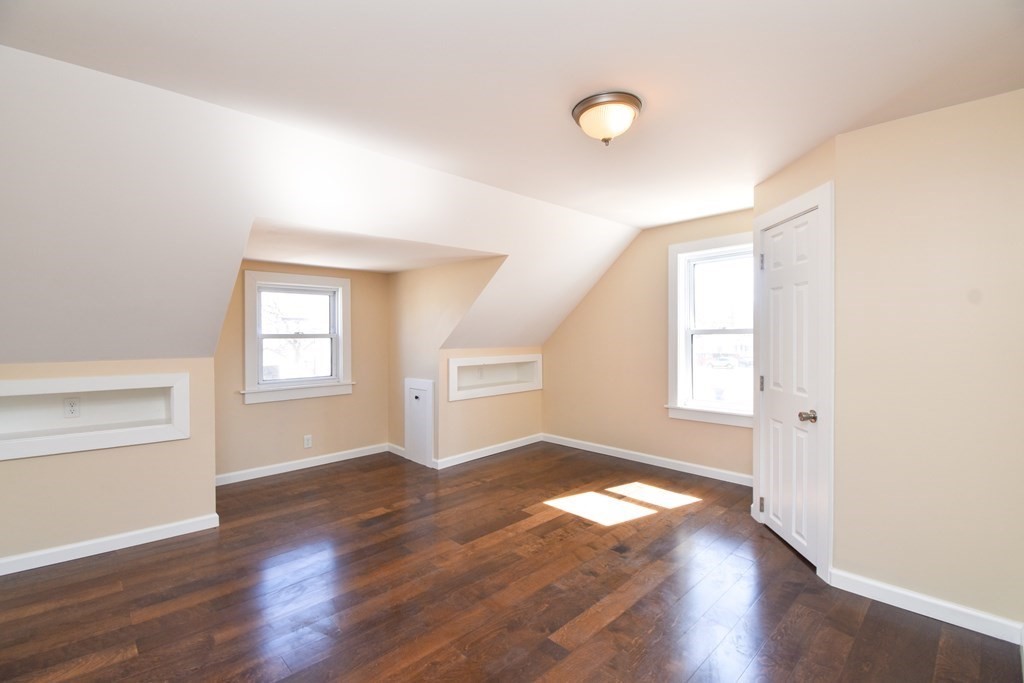 88 Dimmick Street Springfield, MA 01109 - Photo 24 of 36 an empty room with wooden floor and windows