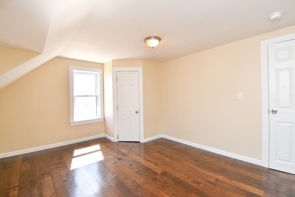 88 Dimmick Street Springfield, MA 01109 - Photo 25 of 36 an empty room with wooden floor and windows