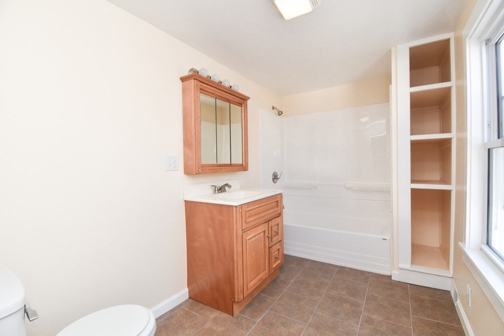 88 Dimmick Street Springfield, MA 01109 - Photo 29 of 36 a bathroom with a sink a toilet and mirror