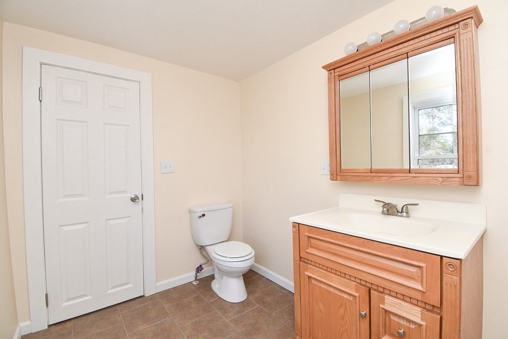 88 Dimmick Street Springfield, MA 01109 - Photo 30 of 36 a bathroom with a toilet sink and a mirror