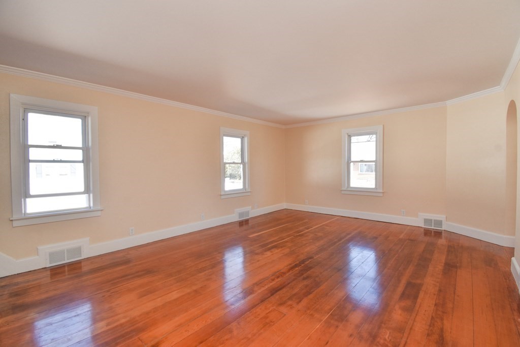 88 Dimmick Street Springfield, MA 01109 - Photo 4 of 36 an empty room with wooden floor and windows