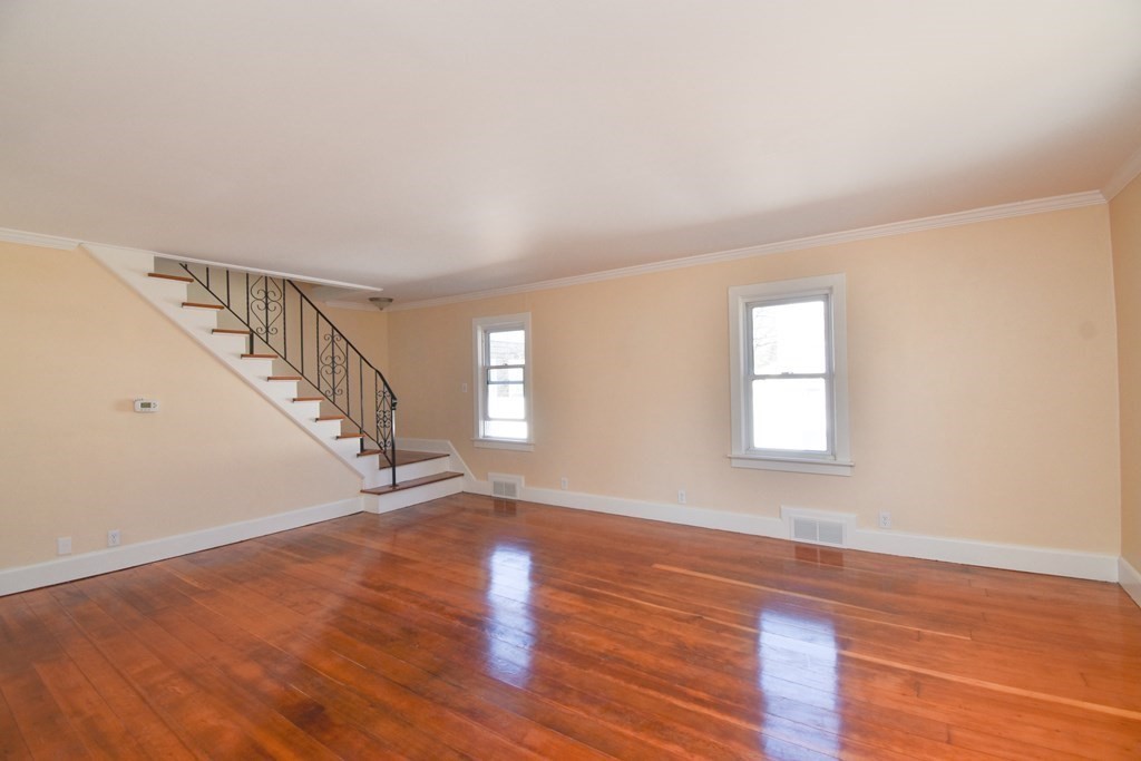 88 Dimmick Street Springfield, MA 01109 - Photo 5 of 36 a view of an empty room with wooden floor and a window