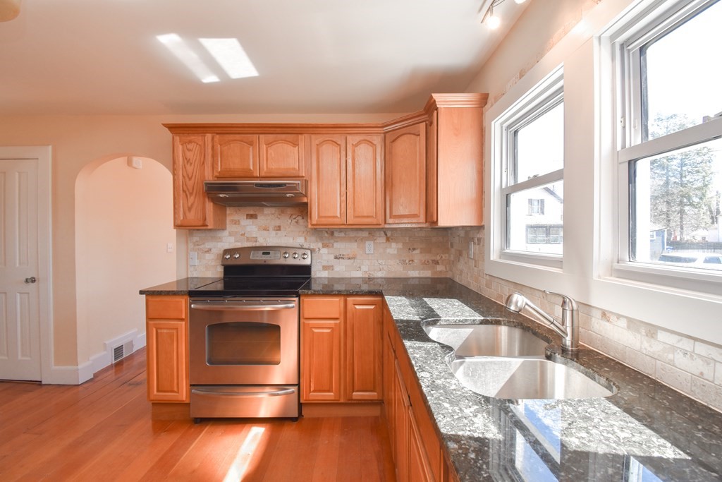 88 Dimmick Street Springfield, MA 01109 - Photo 9 of 36 a kitchen with granite countertop wooden floors and wide window