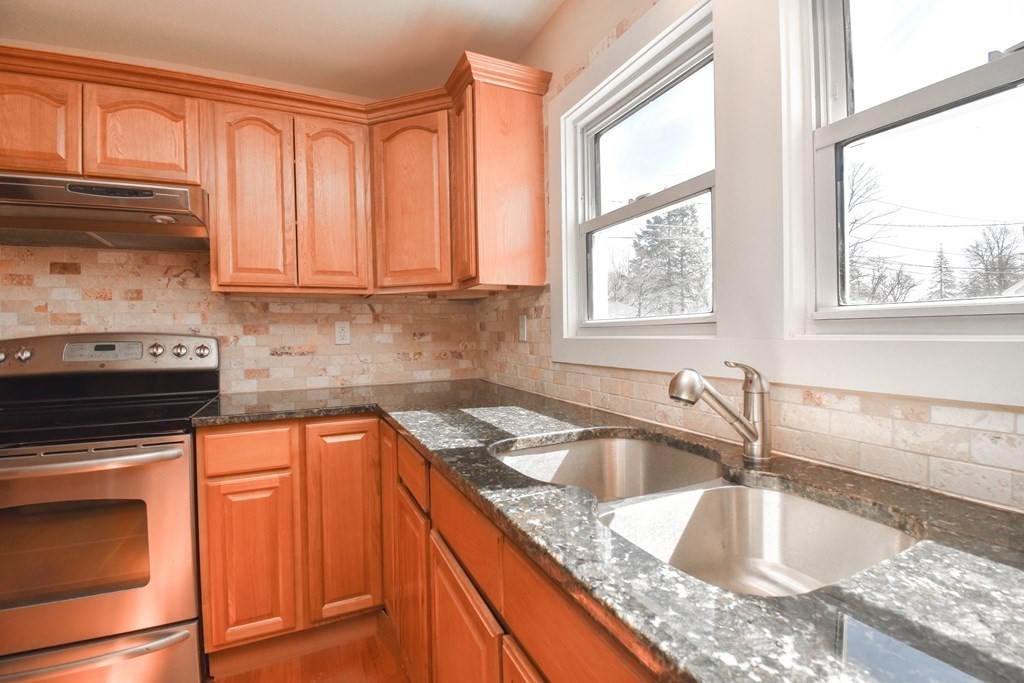 88 Dimmick Street Springfield, MA 01109 - Photo 10 of 36 a kitchen with granite countertop a sink stove and cabinets