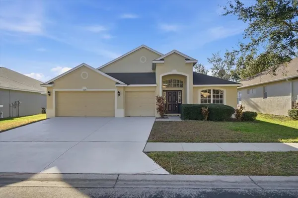 a front view of a house with a yard and garage