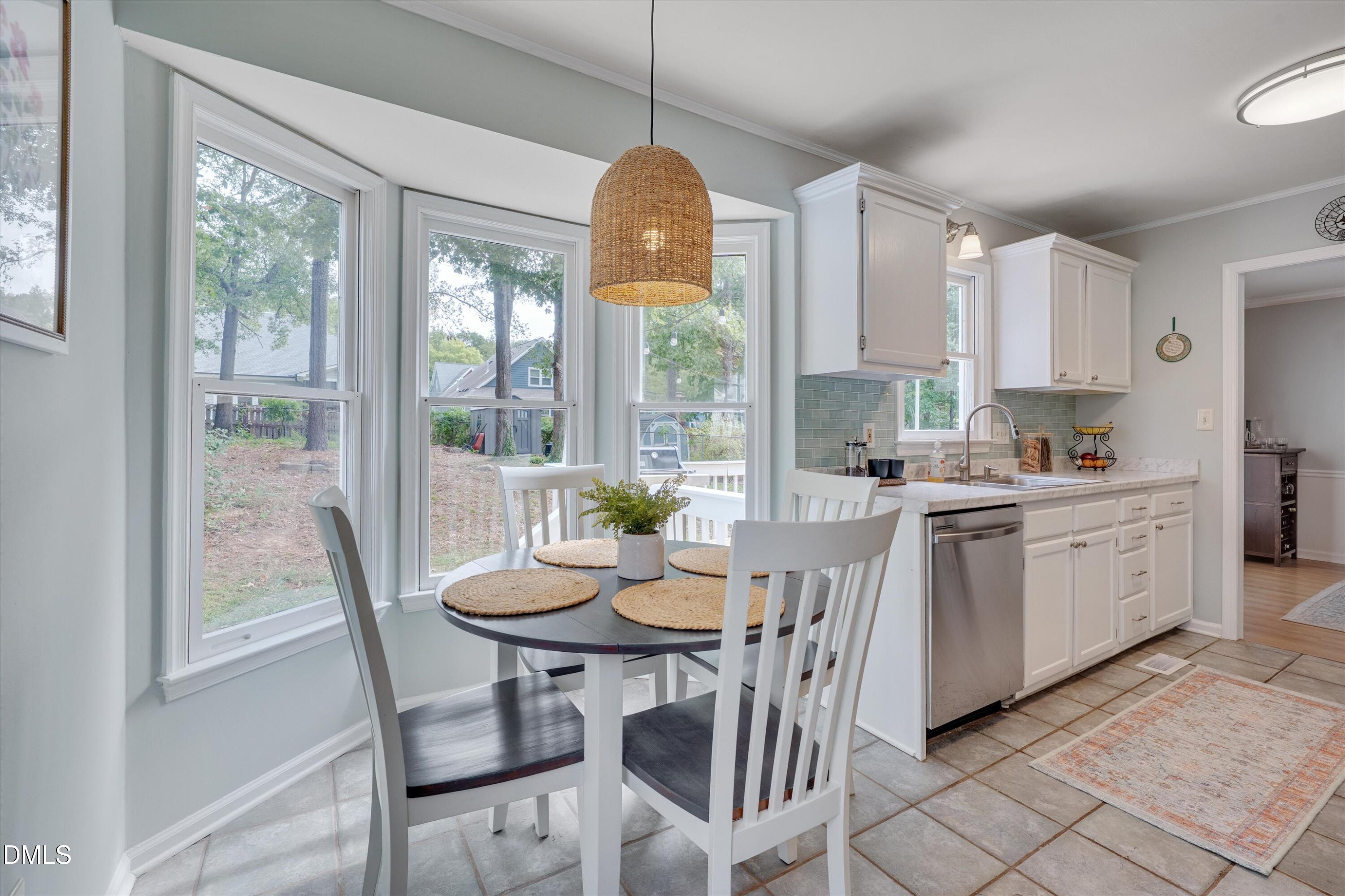 3301 Lassiter Street Durham, NC 27707 - Photo 15 of 32 a kitchen with a table chairs and microwave