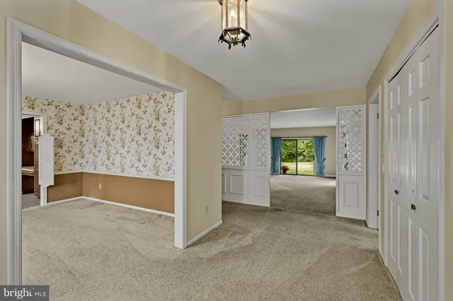 a view of an empty room with window and cabinet
