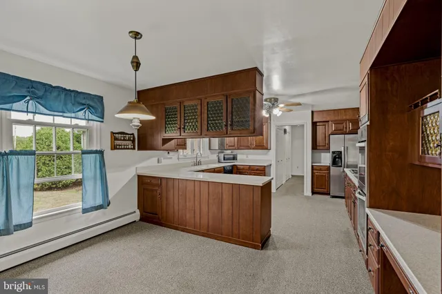 a kitchen with stainless steel appliances granite countertop a stove and a sink