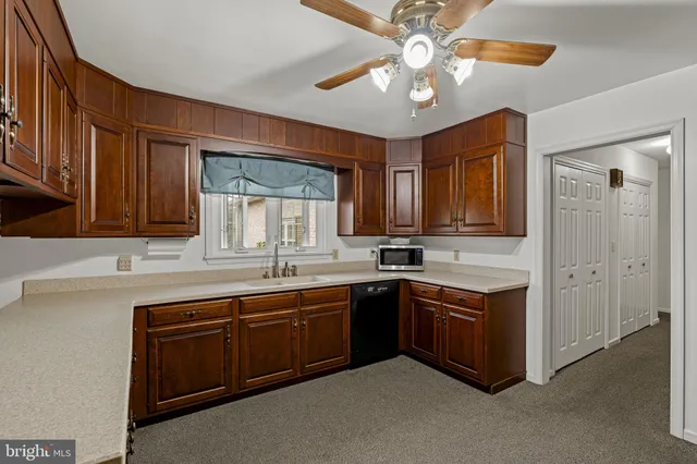 a kitchen with sink and cabinets