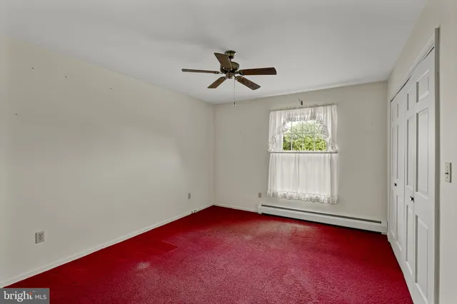 an empty room with a empty space and windows