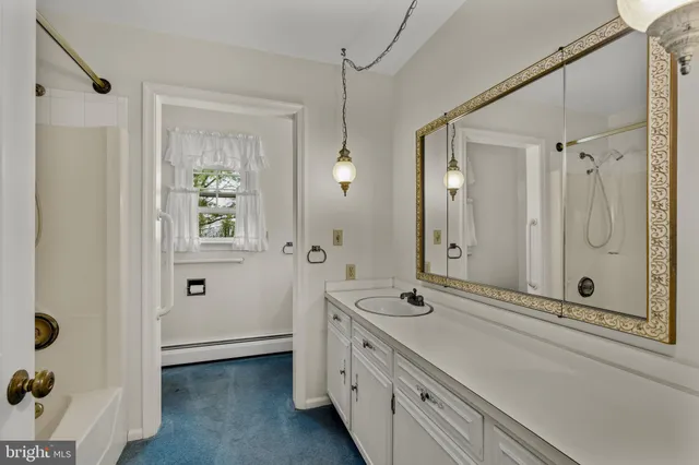 a spacious bathroom with a shower and a sink