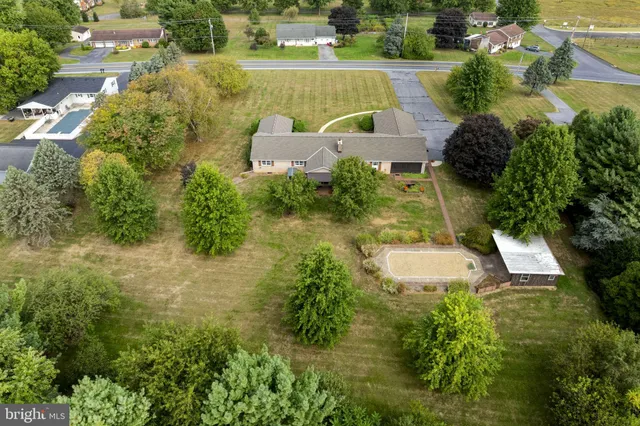 an aerial view of a house with a yard and lake view