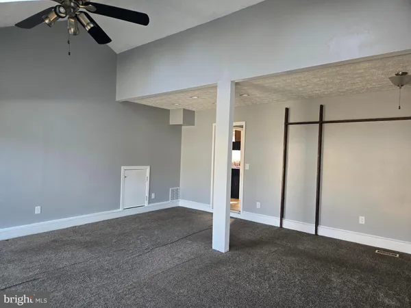 an empty room with a empty space and windows