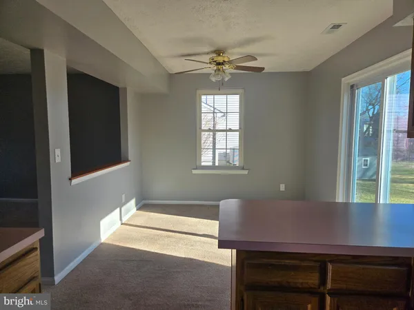 a view of a workspace with furniture and window
