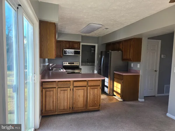 a kitchen with stainless steel appliances a refrigerator and a stove