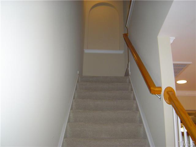 2714 Chilton Place Raleigh, NC 27616 - Photo 14 of 25 Staircase with arched alcove at top.