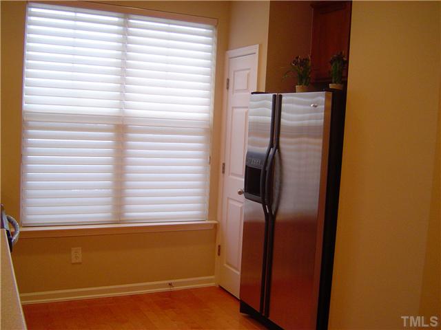 2714 Chilton Place Raleigh, NC 27616 - Photo 5 of 25 Hunter Douglas Blinds and Stainless Steel Refrigerator in kitchen.