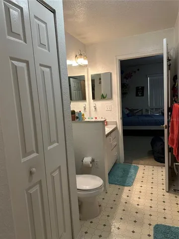 a bathroom with a sink a toilet and mirror